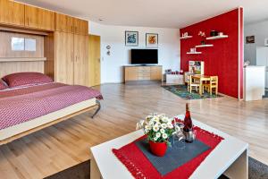 a bedroom with a bed and a table with a bottle of wine at Terrassenpark Schonach App 161 in Schonach