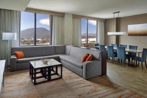 a living room with a couch and a table at Chattanooga Marriott Downtown in Chattanooga