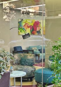 a store window with a table and a painting at Ramada by Wyndham Downtown Beirut in Beirut