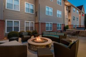 a patio with a fire pit in front of a building at Residence Inn Tallahassee North I-10 Capital Circle in Tallahassee