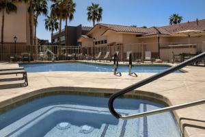 a swimming pool with a hose coming out of it at Residence Inn by Marriott Phoenix Airport in Phoenix