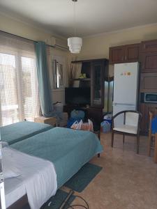 a bedroom with a bed and a refrigerator in it at Zante 523 in Laganas