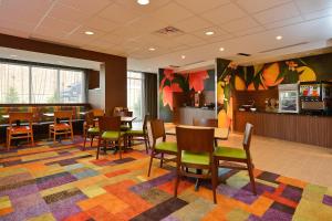 a restaurant with chairs and tables and a bar at Fairfield Inn & Suites by Marriott Elmira Corning in Horseheads