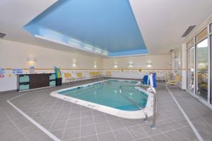 a swimming pool in a large room with a large window at Fairfield Inn & Suites by Marriott Elmira Corning in Horseheads