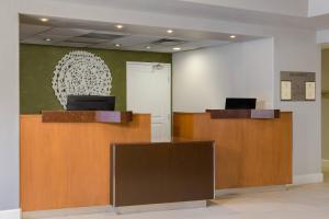 a lobby with two desks and a wall with a sculpture at Fairfield Inn & Suites San Diego Old Town in San Diego