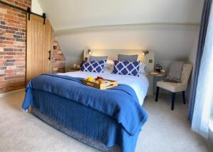 a bedroom with a large bed with a tray on it at Beautiful 3 bed cottage in Lymington. Perfectly located for Coast and New Forest in Lymington