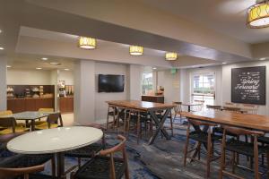 a restaurant with tables and chairs and a chalkboard at Fairfield Inn & Suites San Diego Old Town in San Diego