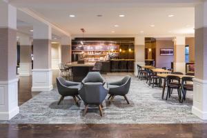 a lobby of a hotel with chairs and a bar at Courtyard Clemson in Clemson