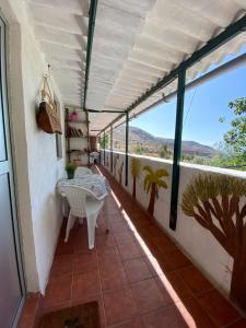 a balcony with a table and a view of the mountains at B&B and Apartments El Charco Azul in El Risco