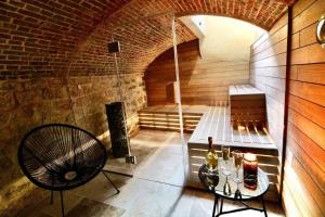 a room with a sauna with a table and a chair at Le Spa Beauvoisine - Jacuzzi Sauna Rouen centre Free parking in Rouen +13 photos
