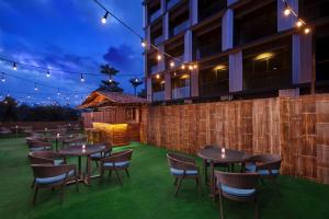 a row of tables and chairs on a lawn with lights at Four Points by Sheraton Balikpapan in Balikpapan