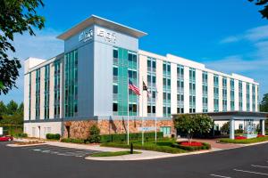 a building with an american flag in front of it at Aloft Charlotte Ballantyne in Charlotte