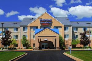 a hotel with a sign on the front of a building at Fairfield Inn & Suites Traverse City in Traverse City