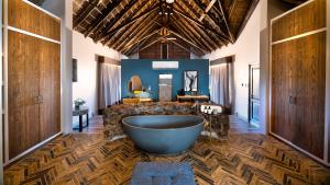 a large bathroom with a large tub in the middle at Babohi at Qwabi Private Game Reserve by NEWMARK in Bela-Bela
