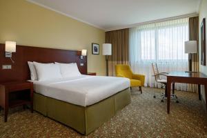 a hotel room with a large bed and a desk at Courtyard by Marriott Düsseldorf Seestern in Düsseldorf