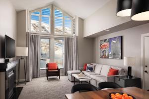 a living room with a couch and a large window at Marriott's MountainSide in Park City