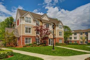 a large house with a lawn in front of it at Residence Inn Saddle River in Saddle River