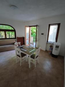 a dining room with a table and two chairs at Yellow house 2 in Cuasso Al Monte