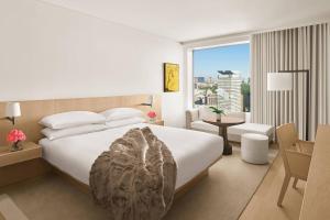 a hotel room with a bed and a large window at The Tokyo EDITION, Toranomon in Tokyo