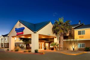 a front view of a hotel with a palm tree at Fairfield Inn & Suites Midland in Midland