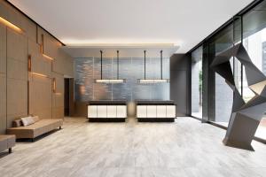 a lobby with a waiting area with a couch and windows at AC Hotel by Marriott Tokyo Ginza in Tokyo