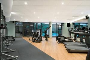 a gym with treadmills and elliptical machines at AC Hotel by Marriott Stockholm Ulriksdal in Solna