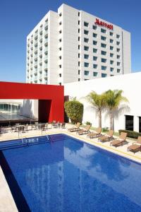 a swimming pool in front of a hotel at Marriott Tijuana Hotel in Tijuana
