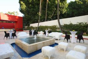 a patio with a fountain and chairs and tables at Marriott Tijuana Hotel in Tijuana