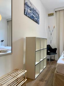 a bedroom with a bed and a mirrored cabinet at Pinzolo DOLOMIA apartment in Pinzolo