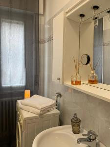 a bathroom with a sink and a mirror at Pinzolo DOLOMIA apartment in Pinzolo