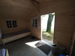 an inside view of a wooden cabin with a window at Häuschen direkt am See in Reichenau