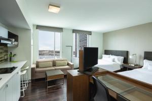 a hotel room with a bed and a living room at Element Boston Seaport District in Boston