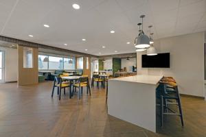 an office lobby with a bar and tables and chairs at Fairfield Inn & Suites by Marriott Milwaukee Brookfield in Brookfield