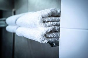 a person is holding a white towel on a door at Sea View Boutique Apartment in Eilat +12 photos