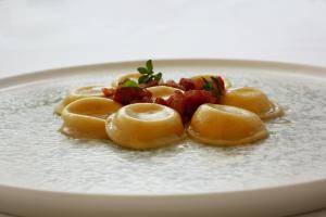 a plate of food with ravioli on it at Principe Alogna Hotel & SPA in Altavilla Milicia