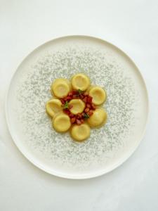 a white plate topped with food on top of sugar at Principe Alogna Hotel & SPA in Altavilla Milicia