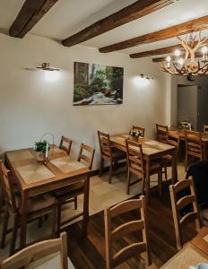 a dining room with wooden tables and chairs at MountHoff Retreat in Moroeni