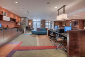 an office with a lobby with a desk and chairs at Fairfield Inn & Suites by Marriott Charlotte Airport in Charlotte
