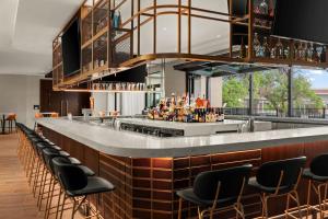 a bar with a row of chairs around it at Marriott San Antonio Airport in San Antonio