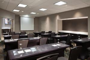 a conference room with tables and chairs and a chalkboard at Residence Inn by Marriott Newark Silicon Valley in Newark