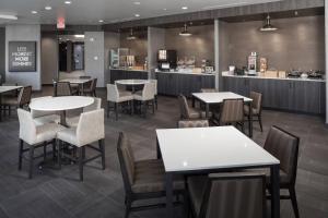 a restaurant with tables and chairs and a counter at Fairfield Inn & Suites by Marriott Oklahoma City Downtown in Oklahoma City