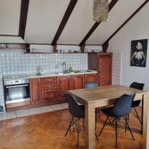 a kitchen with a wooden table and chairs at Apartmani Katarina in Biograd na Moru