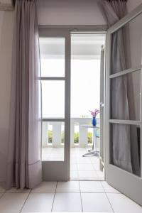 an open door in a room with a window at Keti Apartments in Adelianos Kampos