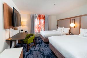 a hotel room with two beds and a desk at Fairfield Inn & Suites Bend Downtown in Bend