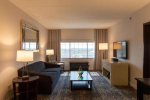 a living room with a couch and a table at Sheraton Chicago Northbrook in Northbrook