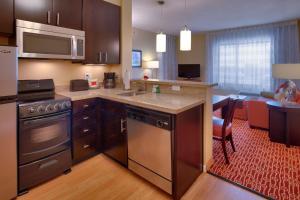 a kitchen with stainless steel appliances and a living room at TownePlace Suites by Marriott Vernal in Vernal