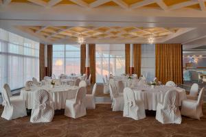 a banquet room with white tables and chairs at Four Points by Sheraton Oran in Oran