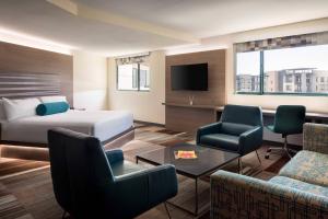 a hotel room with a bed and a tv at Aloft Scottsdale in Scottsdale