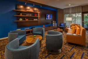 a living room with blue walls and couches and chairs at Courtyard by Marriott Reno Downtown/Riverfront in Reno