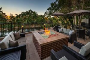 a patio with a fire pit with chairs and tables at Courtyard by Marriott Reno Downtown/Riverfront in Reno